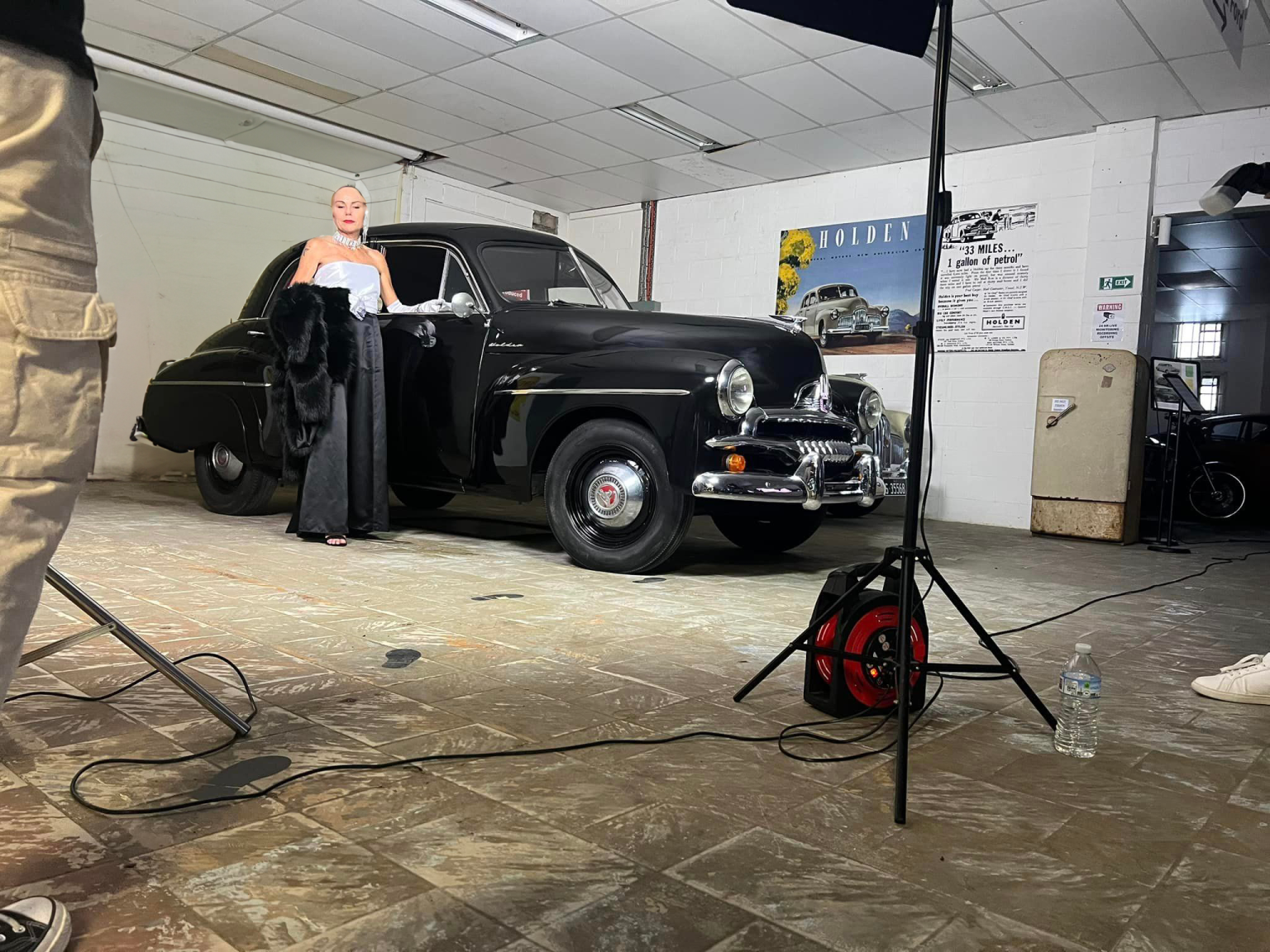 Classic black Holden on display under studio lights