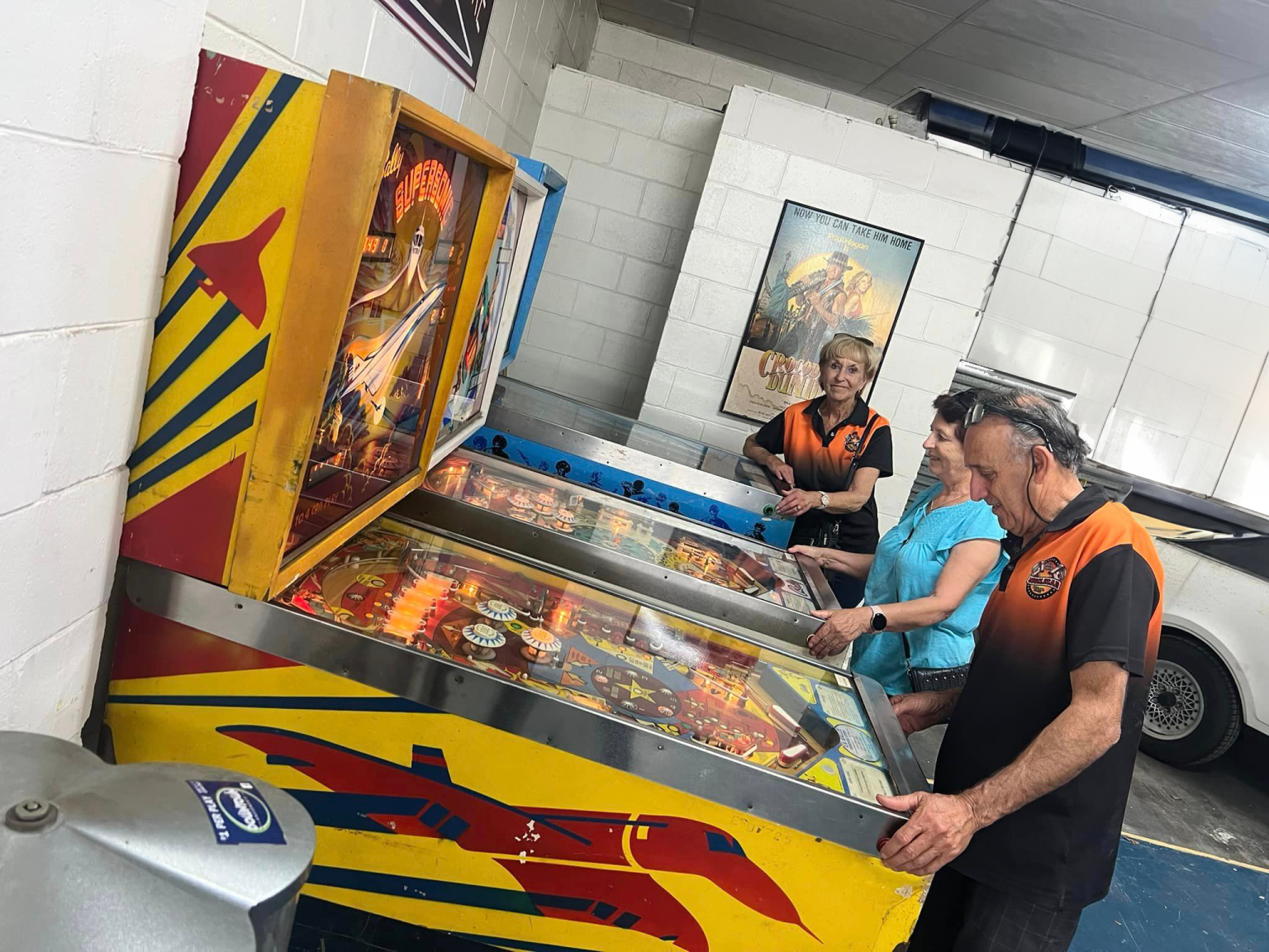 Visitors playing a classic pinball machine