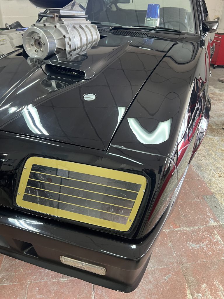 Gold headlight grille and supercharger on the front of the Interceptor