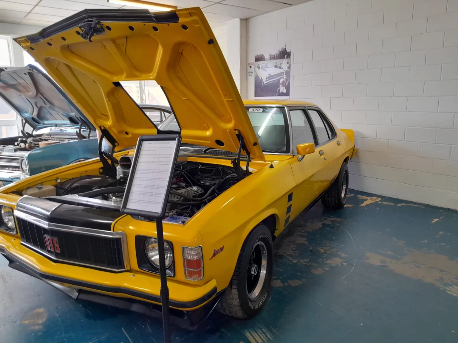 Yellow Holden Torana with its bonnet open