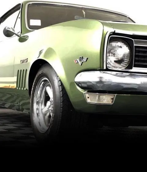 Front corner of a green Holden Monaro GTS with GTS and 350 badges, side vents and chrome wheel